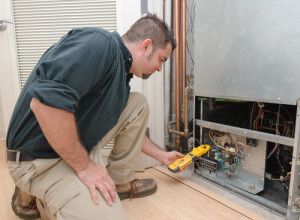 Tech performing heat pump maintenance