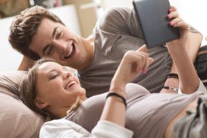 Couple programming their home comfort system with their tablet