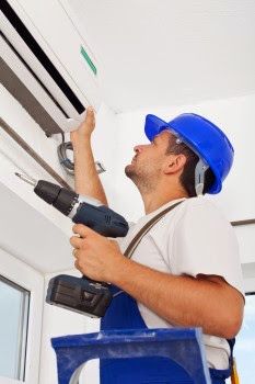 AC tech installing a ductless AC system